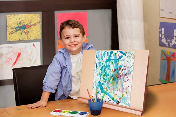 Kid using wooden easel
